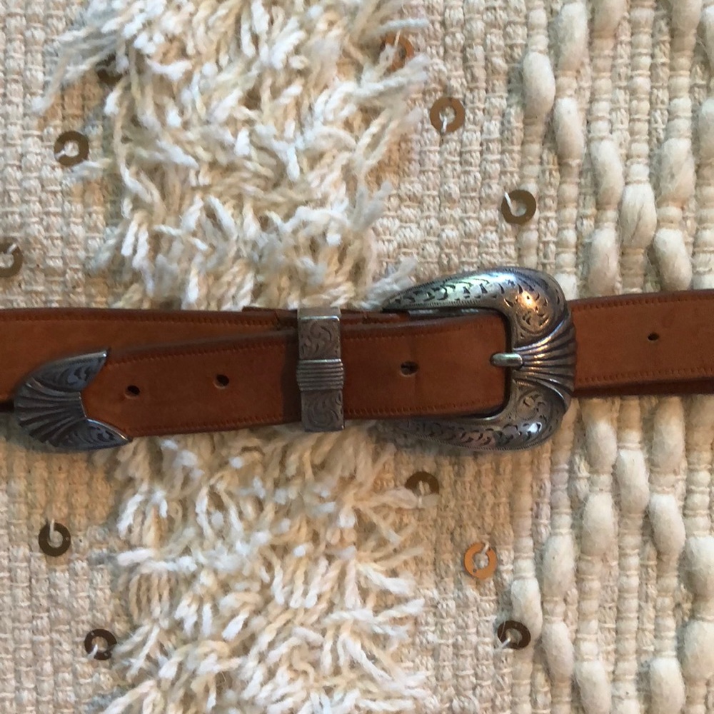 Tan leather belt with silver buckle